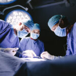 Group of surgeons doing surgery in hospital