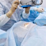 Doctor performing eye surgery in operating room